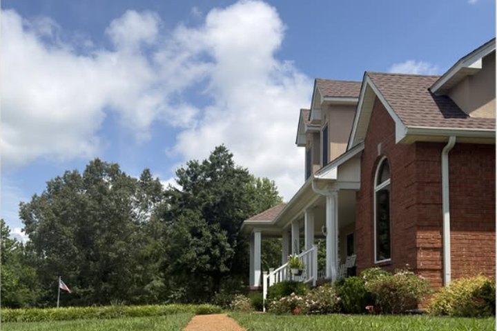Brick home with a freshly cleaned stone walkway and lawn