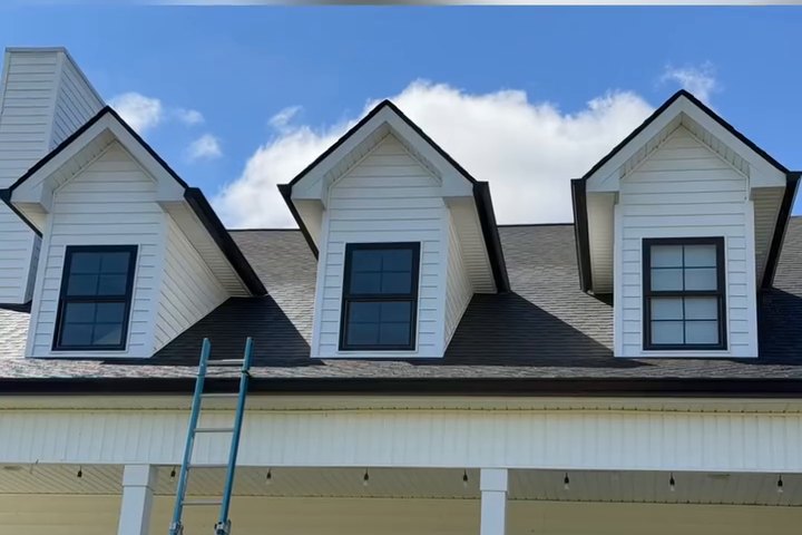 Covered front porch with white columns on a freshly washed home