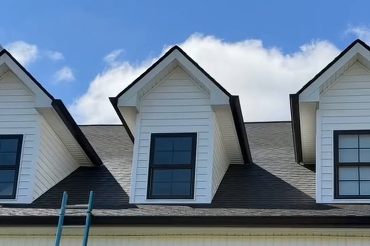 Dark framed windows on a freshly washed white house